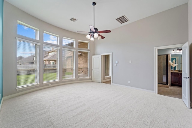 19403 Shady Edge Dr, Cypress, TX 77433 - spare room with light colored carpet, baseboards, a towering ceiling, and plenty of natural light