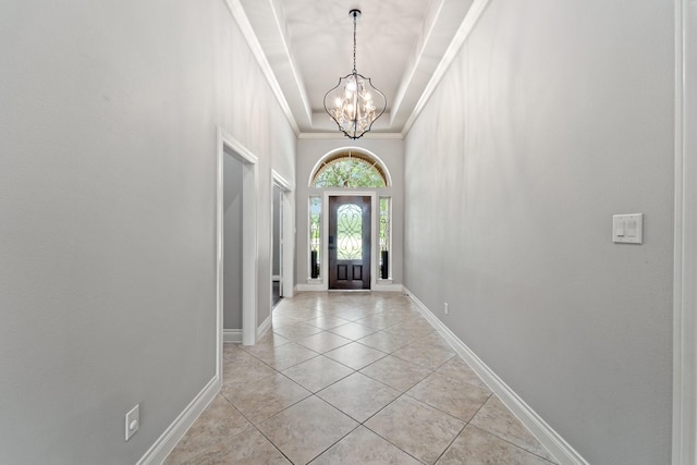 19403 Shady Edge Dr, Cypress, TX 77433 - foyer entrance with a chandelier, light tile patterned floors, crown molding, and baseboards