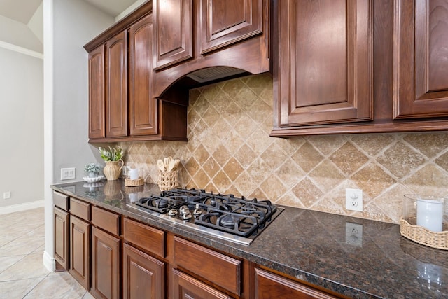 19403 Shady Edge Dr, Cypress, TX 77433 - kitchen featuring gas stovetop, backsplash, dark stone counters, and baseboards