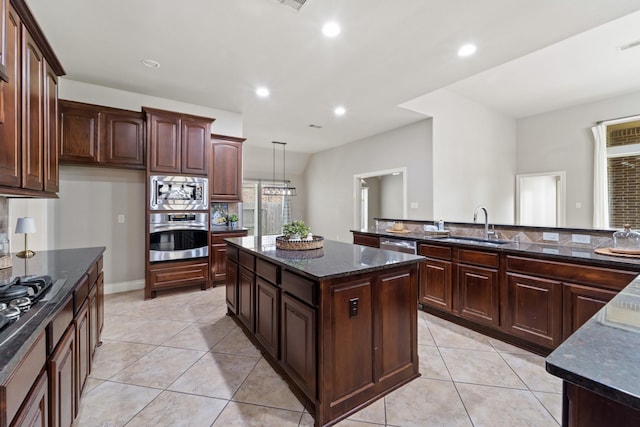 19403 Shady Edge Dr, Cypress, TX 77433 - kitchen with appliances with stainless steel finishes, light tile patterned floors, a center island, recessed lighting, and dark stone counters