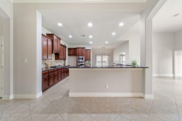 19403 Shady Edge Dr, Cypress, TX 77433 - kitchen featuring dark countertops, appliances with stainless steel finishes, light tile patterned floors, baseboards, and recessed lighting