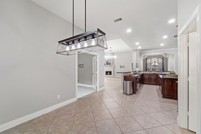19403 Shady Edge Dr, Cypress, TX 77433 - kitchen with a chandelier, arched walkways, open floor plan, recessed lighting, and dark brown cabinets