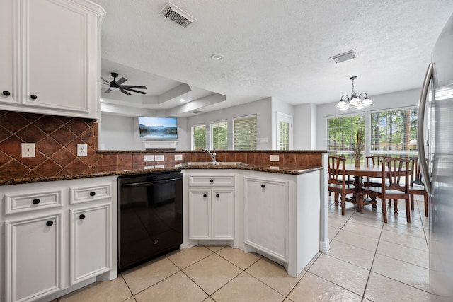 402 Eastwood Dr, Woodbranch, TX 77357 - kitchen featuring black dishwasher, a sink, freestanding refrigerator, a chandelier, and decorative backsplash