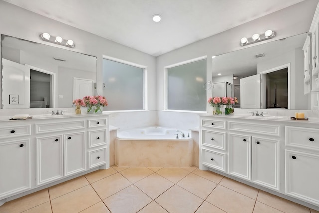 402 Eastwood Dr, Woodbranch, TX 77357 - bathroom with two vanities, a bath, and tile patterned floors