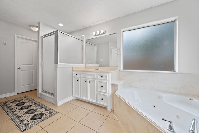 402 Eastwood Dr, Woodbranch, TX 77357 - full bathroom featuring tile patterned floors, vanity, a jetted tub, and a stall shower