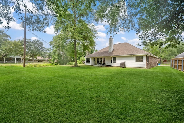 402 Eastwood Dr, Woodbranch, TX 77357 - back of property featuring a chimney and a patio area