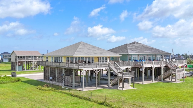 1508 Galveston Ave, Port Bolivar, TX 77650 - back of property with stairs, a patio, a lawn, and a deck