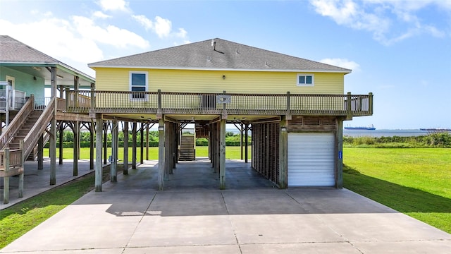 1508 Galveston Ave, Port Bolivar, TX 77650 - view of home's community with a carport, a yard, driveway, a deck, and stairs