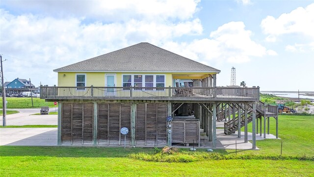 1508 Galveston Ave, Port Bolivar, TX 77650 - back of property featuring a wooden deck, a patio area, a lawn, stairs, and a shingled roof
