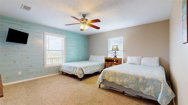 1508 Galveston Ave, Port Bolivar, TX 77650 - bedroom featuring wooden walls, carpet, a ceiling fan, and baseboards