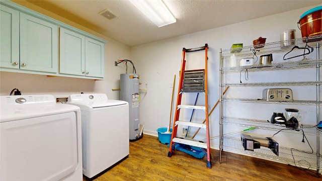 1508 Galveston Ave, Port Bolivar, TX 77650 - washroom with cabinet space, separate washer and dryer, water heater, wood finished floors, and baseboards