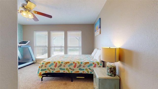 1508 Galveston Ave, Port Bolivar, TX 77650 - bedroom featuring carpet floors, a textured wall, and ceiling fan