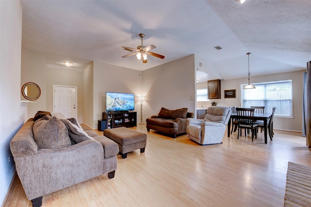 8123 Sweetgum Trace Dr, Houston, TX 77040 - living area with a ceiling fan, light wood finished floors, a textured ceiling, vaulted ceiling, and baseboards