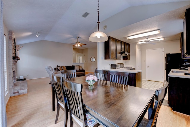 8123 Sweetgum Trace Dr, Houston, TX 77040 - dining area featuring ceiling fan, vaulted ceiling, baseboards, and light wood-type flooring
