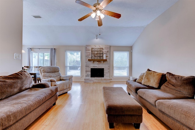 8123 Sweetgum Trace Dr, Houston, TX 77040 - living area featuring lofted ceiling, a ceiling fan, light wood-style floors, a large fireplace, and track lighting