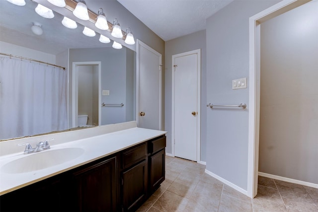8123 Sweetgum Trace Dr, Houston, TX 77040 - bathroom with vanity, toilet, tile patterned flooring, and baseboards