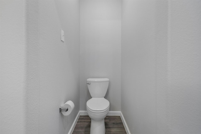 6902 White Ash Ln, Baytown, TX 77521 - bathroom featuring wood finished floors, toilet, and baseboards