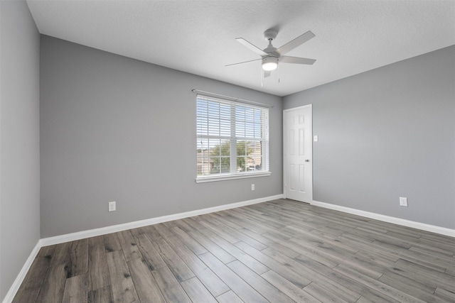 6902 White Ash Ln, Baytown, TX 77521 - spare room with wood finished floors, ceiling fan, baseboards, and a textured ceiling