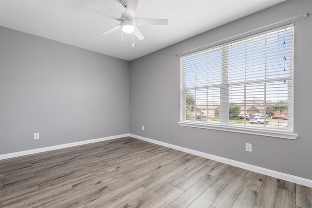 6902 White Ash Ln, Baytown, TX 77521 - unfurnished room with wood finished floors, a ceiling fan, and baseboards