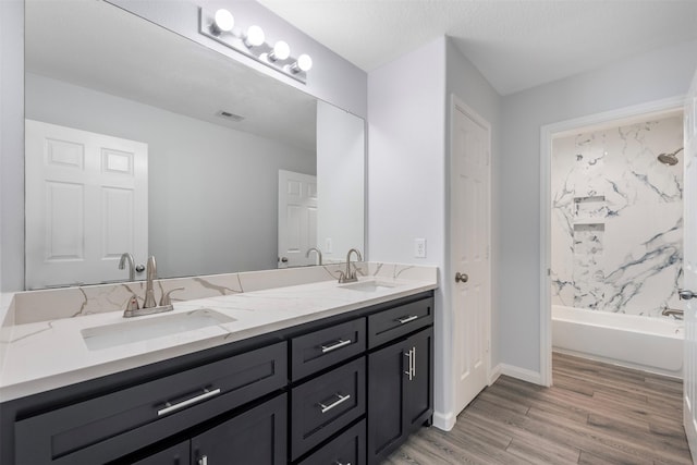 6902 White Ash Ln, Baytown, TX 77521 - full bathroom featuring double vanity, wood finished floors, shower / tub combination, and baseboards