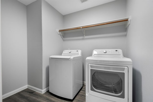6902 White Ash Ln, Baytown, TX 77521 - laundry room with washer and dryer, dark wood-style floors, and baseboards