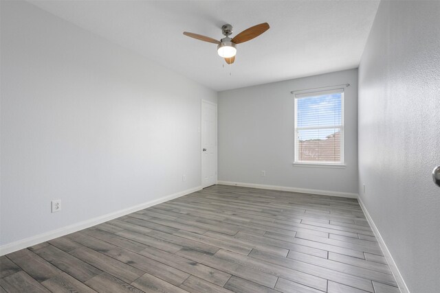 6902 White Ash Ln, Baytown, TX 77521 - unfurnished room with ceiling fan, wood finished floors, and baseboards