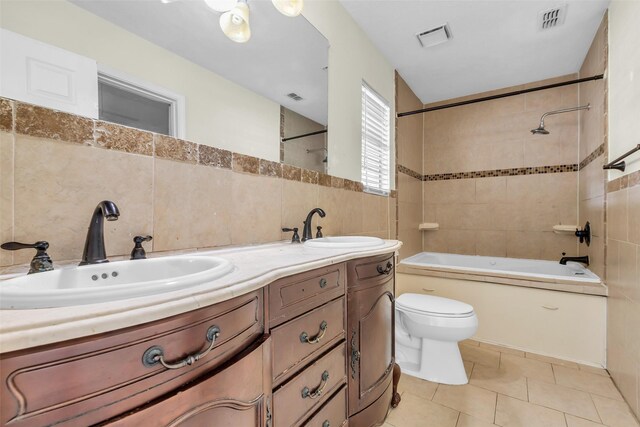 15830 Pipers View Dr, Houston, TX 77598 - full bath with tile walls, washtub / shower combination, toilet, double vanity, and tile patterned floors