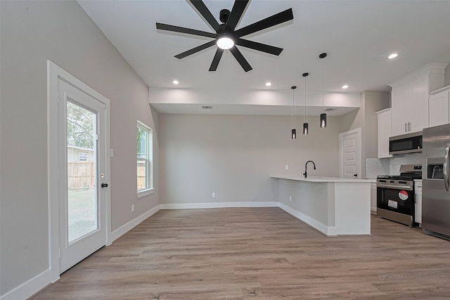 7911 Carver Rd, Houston, TX 77088 - kitchen featuring stainless steel appliances, decorative backsplash, light countertops, ceiling fan, and white cabinetry