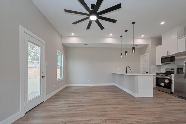 7911 Carver Rd, Houston, TX 77088 - kitchen featuring appliances with stainless steel finishes, decorative backsplash, light countertops, a ceiling fan, and white cabinets