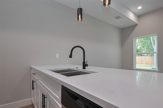 7911 Carver Rd, Houston, TX 77088 - kitchen featuring a sink, light countertops, white cabinets, baseboards, and decorative light fixtures