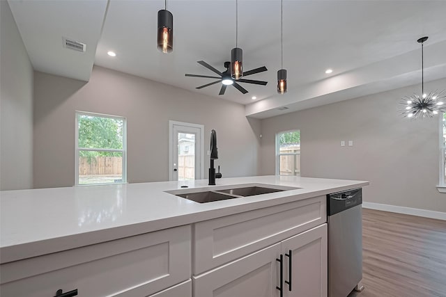 7911 Carver Rd, Houston, TX 77088 - kitchen with stainless steel dishwasher, a sink, light wood-style floors, decorative light fixtures, and recessed lighting