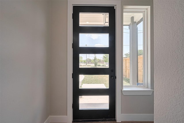 7911 Carver Rd, Houston, TX 77088 - entrance foyer with baseboards, healthy amount of natural light, and a textured wall