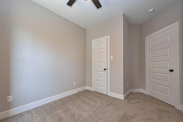 7911 Carver Rd, Houston, TX 77088 - unfurnished bedroom featuring light colored carpet, baseboards, and a ceiling fan