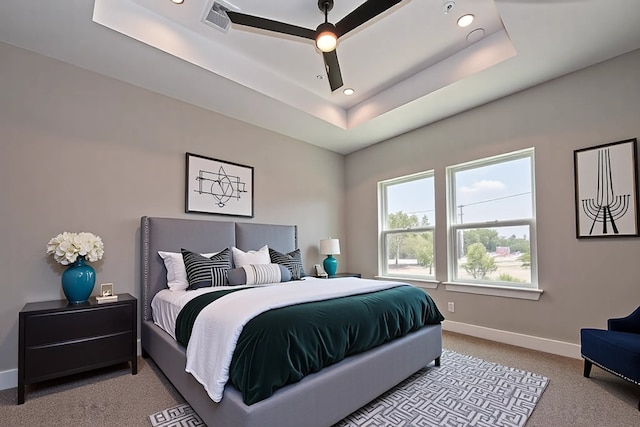 7911 Carver Rd, Houston, TX 77088 - bedroom with a tray ceiling, light colored carpet, baseboards, recessed lighting, and a ceiling fan