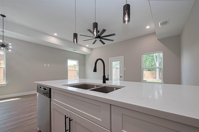7911 Carver Rd, Houston, TX 77088 - kitchen with stainless steel dishwasher, a sink, light wood-style floors, recessed lighting, and decorative light fixtures