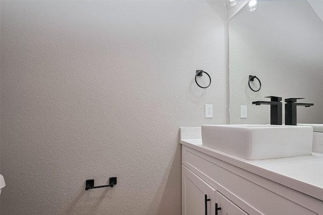 7911 Carver Rd, Houston, TX 77088 - bathroom featuring vanity and a textured wall