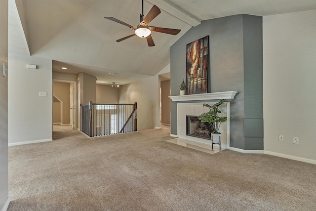 94 S Magnolia Pond Pl, The Woodlands, TX 77381 - unfurnished living room with a ceiling fan, beam ceiling, carpet, a tiled fireplace, and high vaulted ceiling