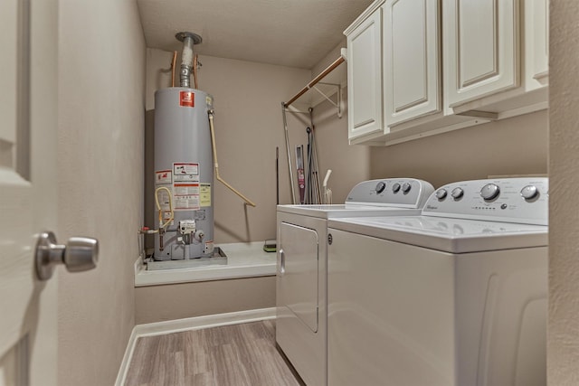 94 S Magnolia Pond Pl, The Woodlands, TX 77381 - washroom with water heater, washing machine and clothes dryer, cabinet space, wood finished floors, and baseboards