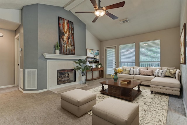 94 S Magnolia Pond Pl, The Woodlands, TX 77381 - carpeted living area featuring a ceiling fan, a tile fireplace, beam ceiling, baseboards, and high vaulted ceiling
