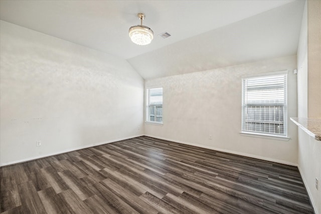 8931 Beacon Mill Dr, Cypress, TX 77433 - empty room featuring dark wood-style floors, vaulted ceiling, and baseboards
