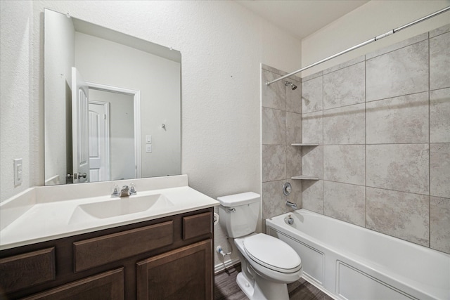8931 Beacon Mill Dr, Cypress, TX 77433 - full bathroom featuring toilet, vanity, a textured wall, shower / bath combination, and wood finished floors
