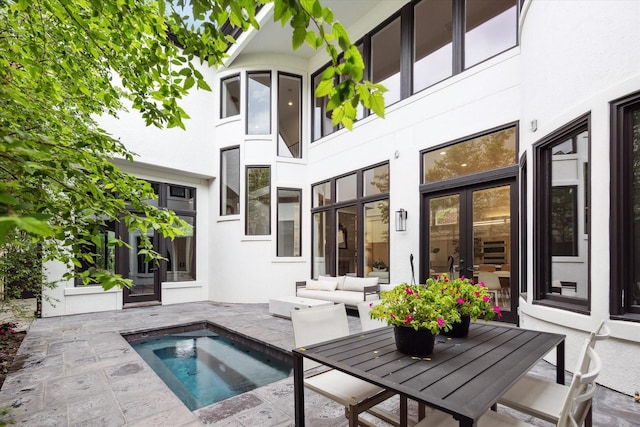 2013 Persa St, Houston, TX 77019 - rear view of property featuring french doors, stucco siding, an in-ground hot tub, and a patio