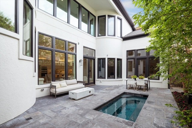 2013 Persa St, Houston, TX 77019 - back of house featuring a patio, an in-ground hot tub, stucco siding, and an outdoor living space