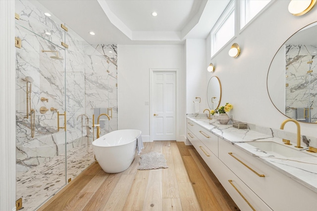 2013 Persa St, Houston, TX 77019 - bathroom featuring a marble finish shower, a freestanding bath, wood finished floors, double vanity, and recessed lighting
