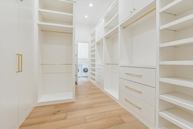 2013 Persa St, Houston, TX 77019 - spacious closet with washer and clothes dryer and light wood-style floors