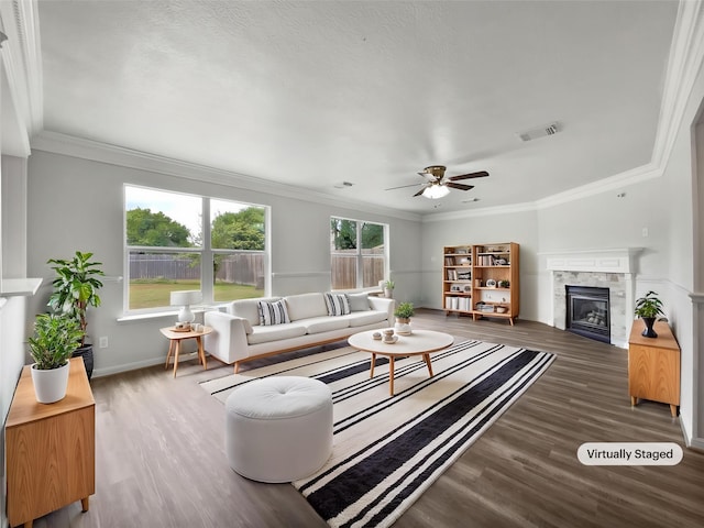 426 N Lindbergh Ct, Baytown, TX 77521 - living area featuring wood finished floors, ceiling fan, crown molding, a glass covered fireplace, and baseboards