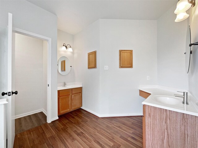 426 N Lindbergh Ct, Baytown, TX 77521 - full bathroom featuring wood finished floors, two vanities, and baseboards
