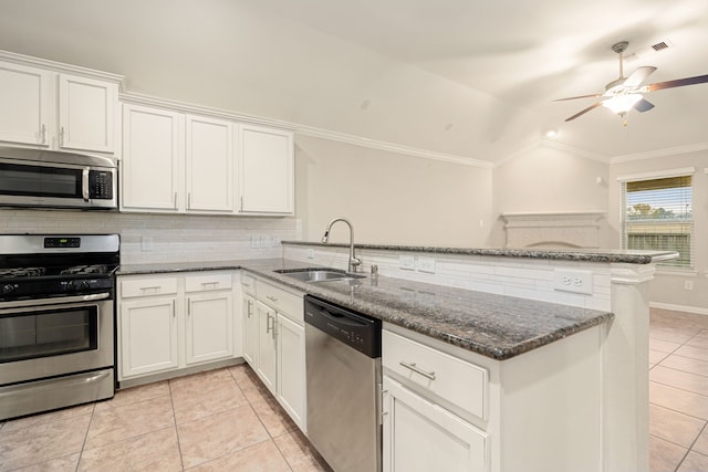 3522 Ember Falls Ln, Katy, TX 77449 - kitchen featuring stainless steel appliances, a peninsula, a sink, light tile patterned floors, and tasteful backsplash