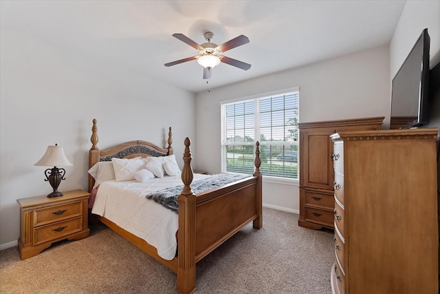 12103 Kaiso Ln, Conroe, TX 77304 - bedroom with baseboards, light colored carpet, and a ceiling fan