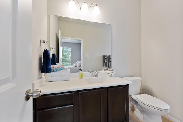 12103 Kaiso Ln, Conroe, TX 77304 - half bath with vanity, toilet, and baseboards